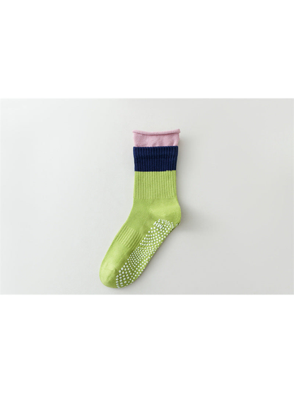 Bright green color-blocked crew sock with navy band and pink rolled edge