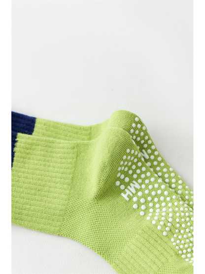 Close-up of raised white dots across the green sock sole