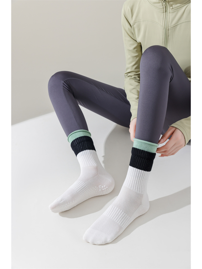 White color-blocked crew socks worn with mesh-like panels across the feet