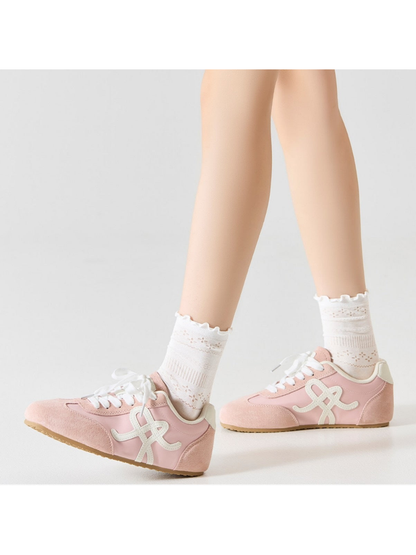 White pointelle crew socks styled with pink sneakers