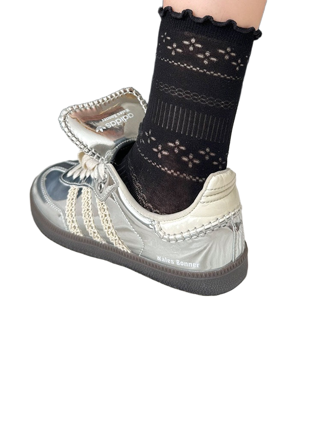 Black pointelle crew sock with a ruffled cuff