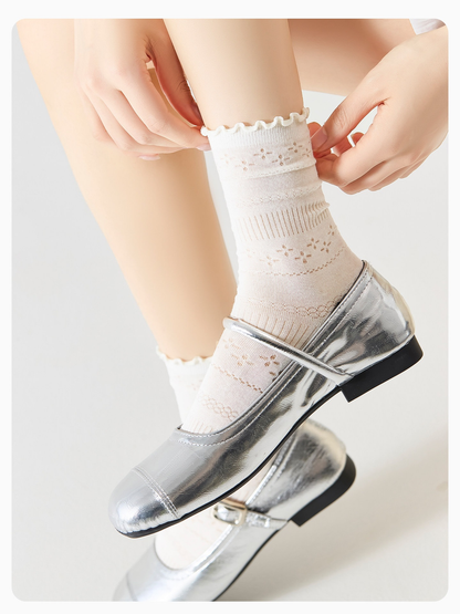 Ivory pointelle crew socks styled with silver shoes