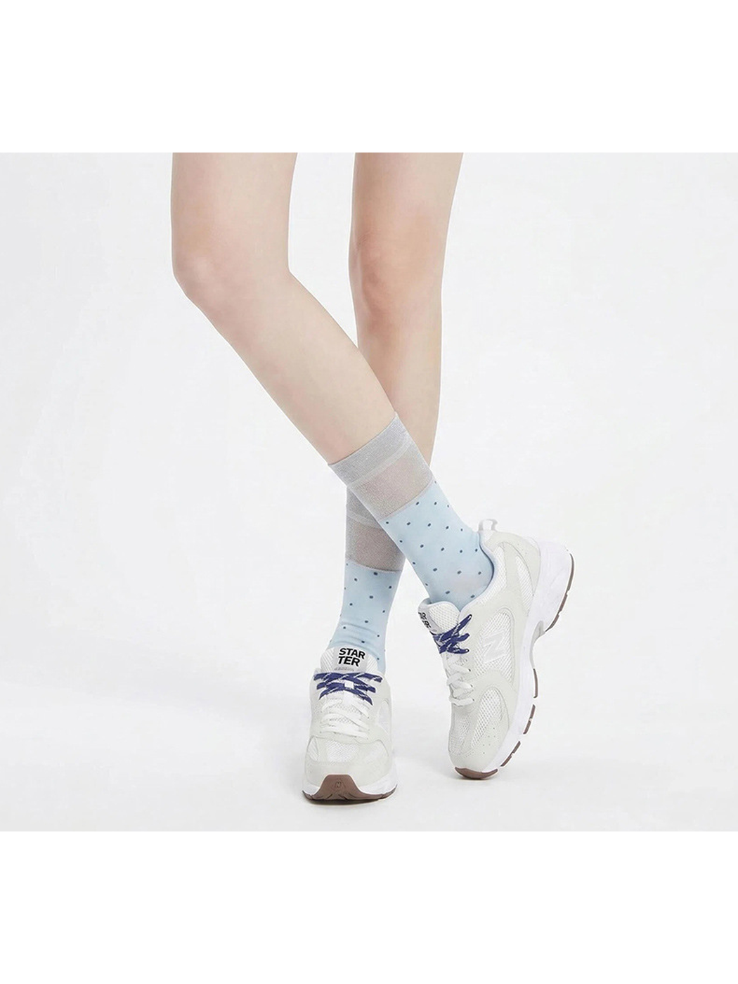 Light blue polka-dot socks worn with white sneakers