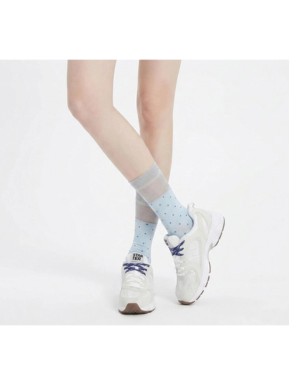 Light blue polka-dot socks worn with white sneakers