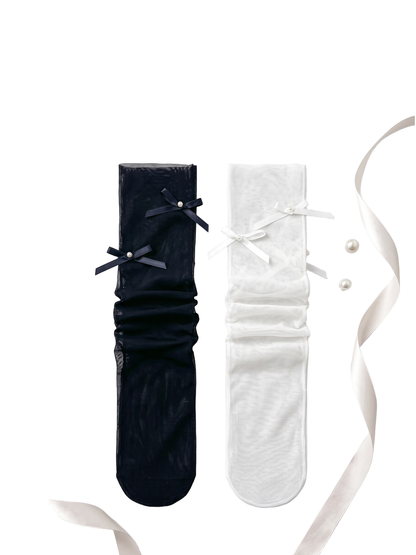 Black and white bow-accent mesh socks arranged side by side