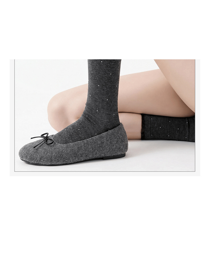 Dark gray dotted socks styled with gray bow flats