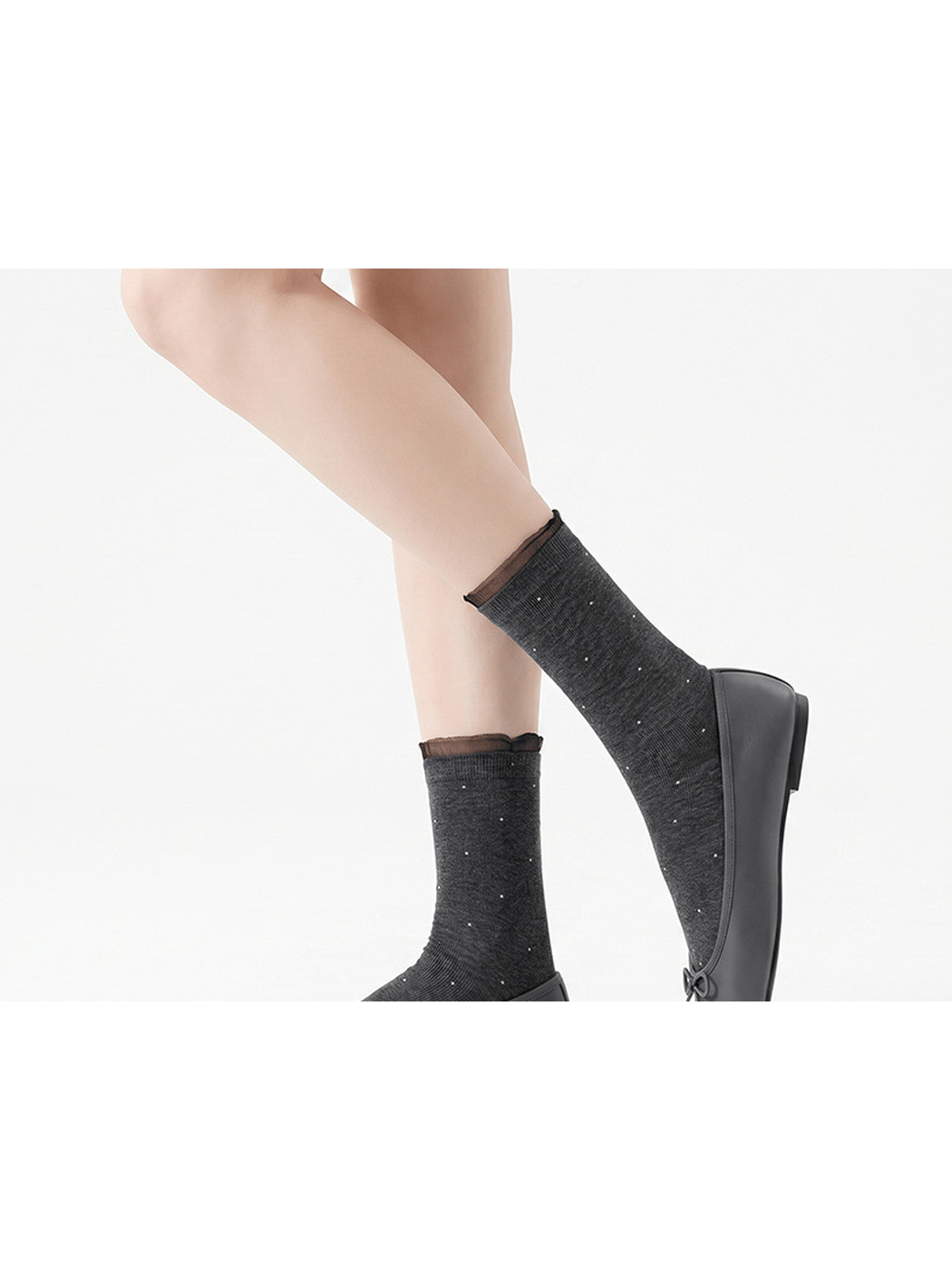 Dark gray dotted socks with ruffled cuffs and black flats