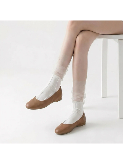 White sheer ruffle crew socks with sparkling dots, worn with brown flats