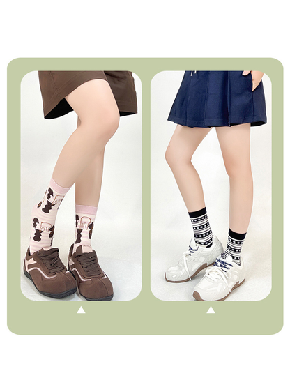 Pink abstract-pattern and black striped socks styled with sneakers