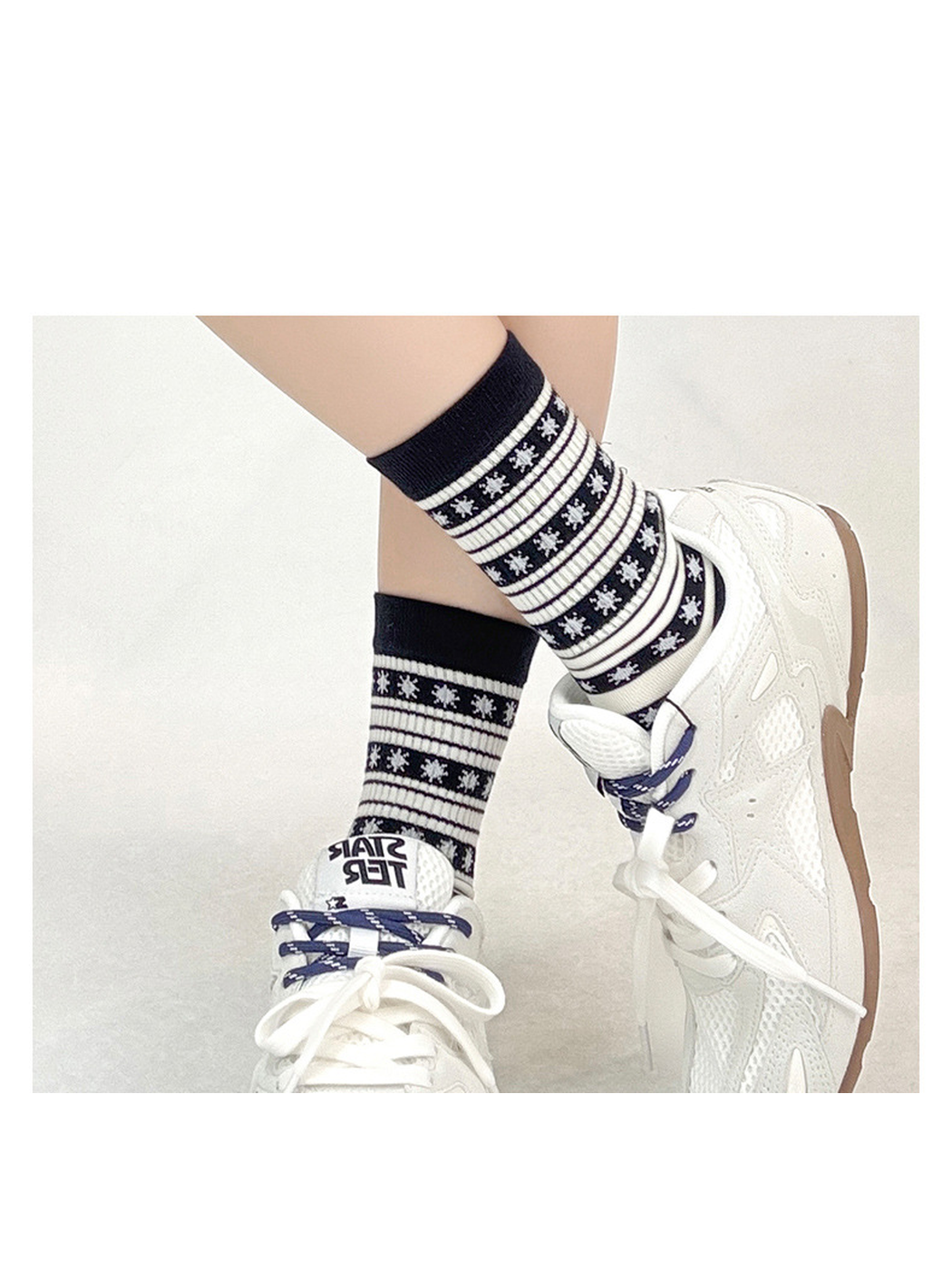 Black striped snowflake socks styled with white sneakers