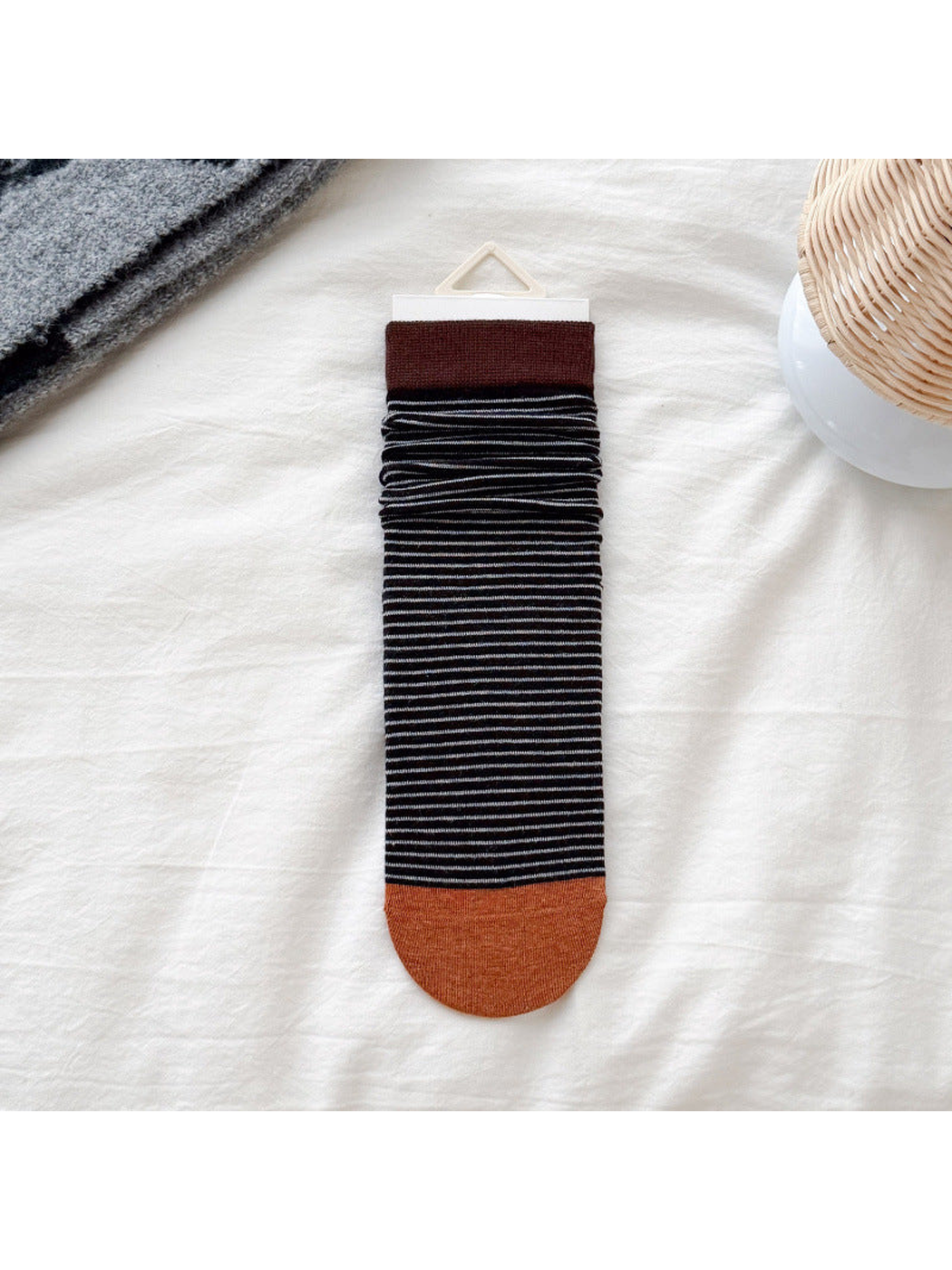 Dark brown cuff black striped crew sock with orange toe, flat display
