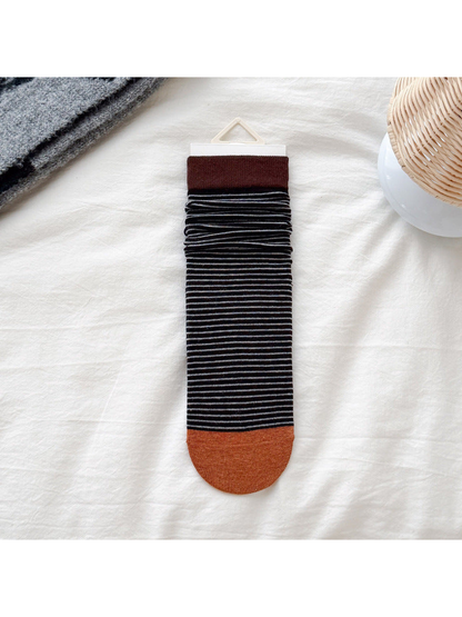 Dark brown cuff black striped crew sock with orange toe, flat display