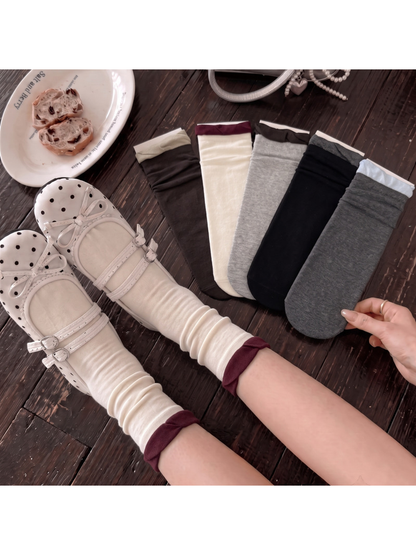 Ivory ruffle-cuff socks styled beside five color options