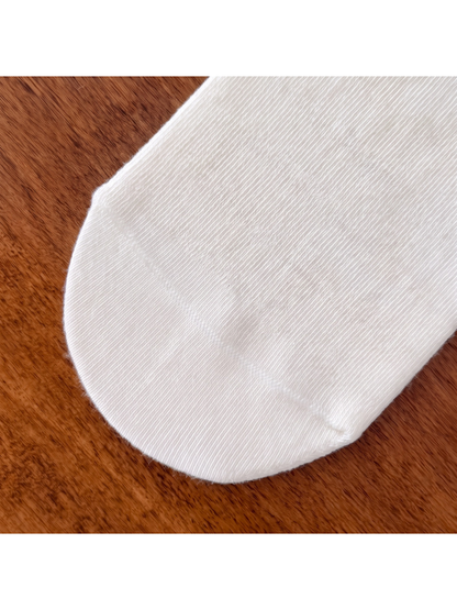 Close-up of the fine knit texture and curved sock toe seam