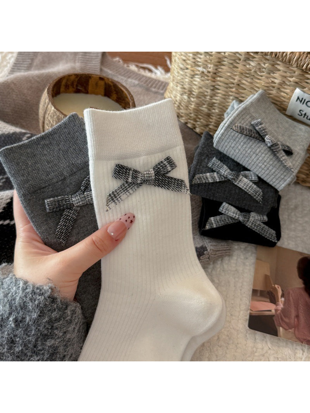 White and gray ribbed crew socks with plaid bows displayed together