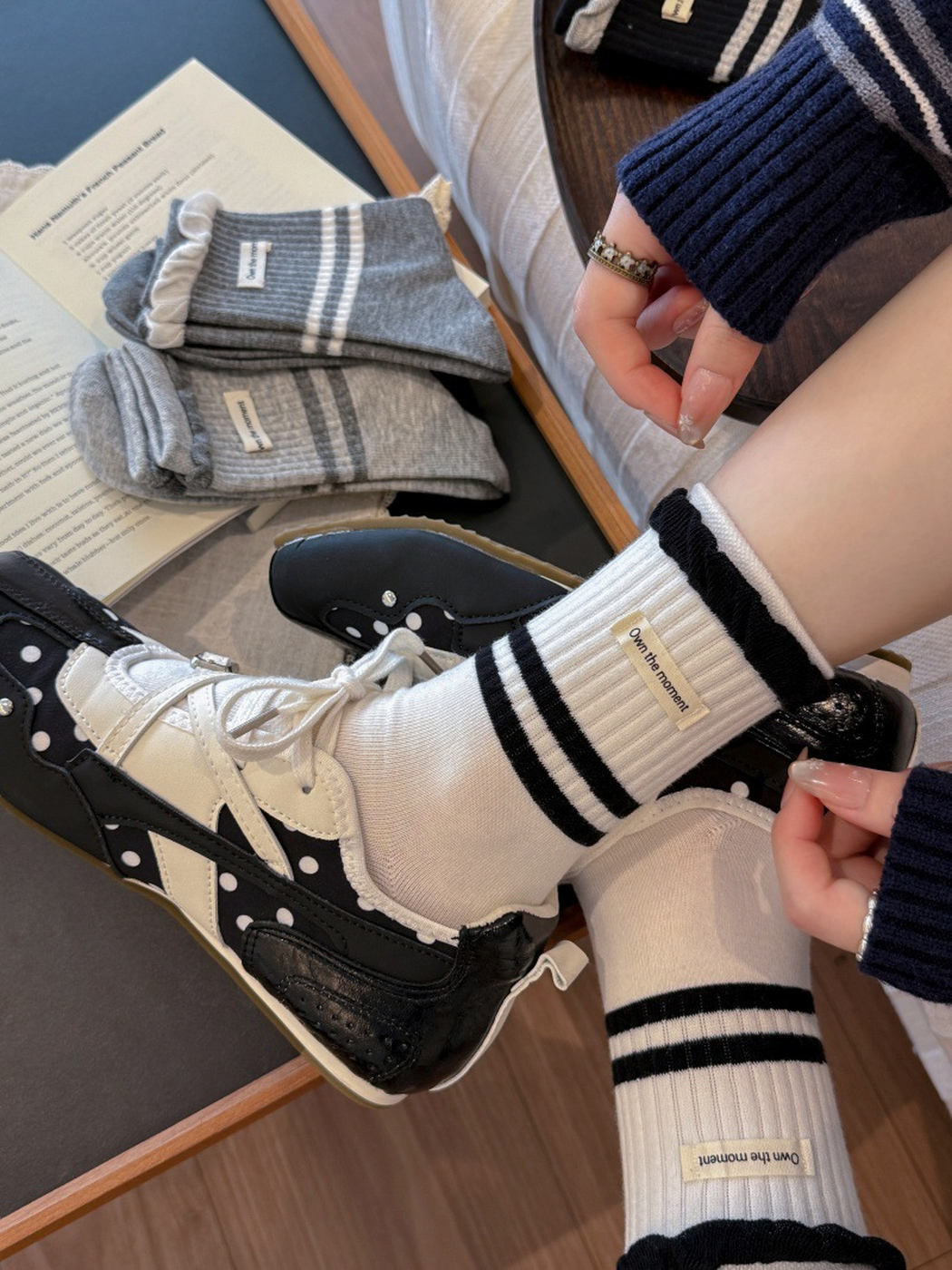 Close-up of white striped crew socks with contrasting ruffled cuffs and labels