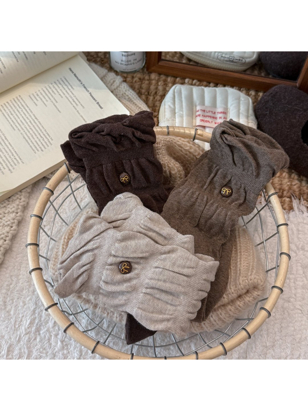 Oatmeal, dark coffee and brown gathered socks arranged in a basket