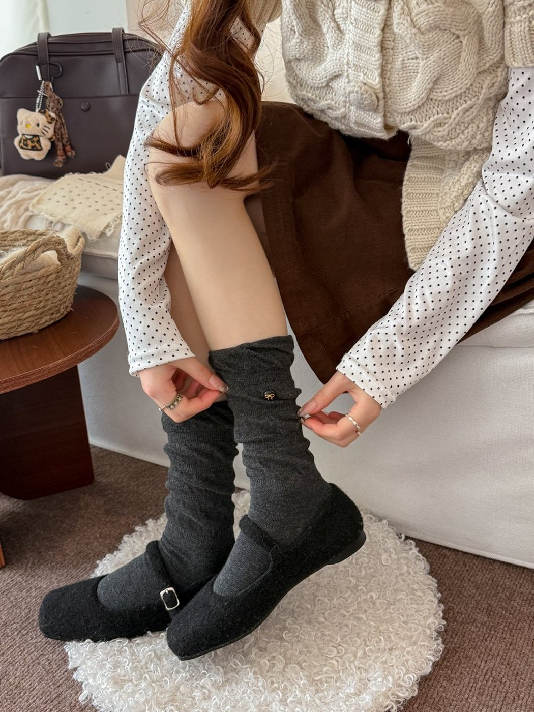 Dark gray gathered crew socks worn with black buckle shoes