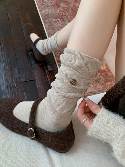 Oatmeal gathered crew sock styled with a brown buckle shoe