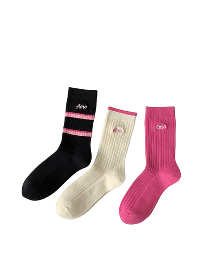 Pink, ivory and black ribbed crew socks displayed side by side