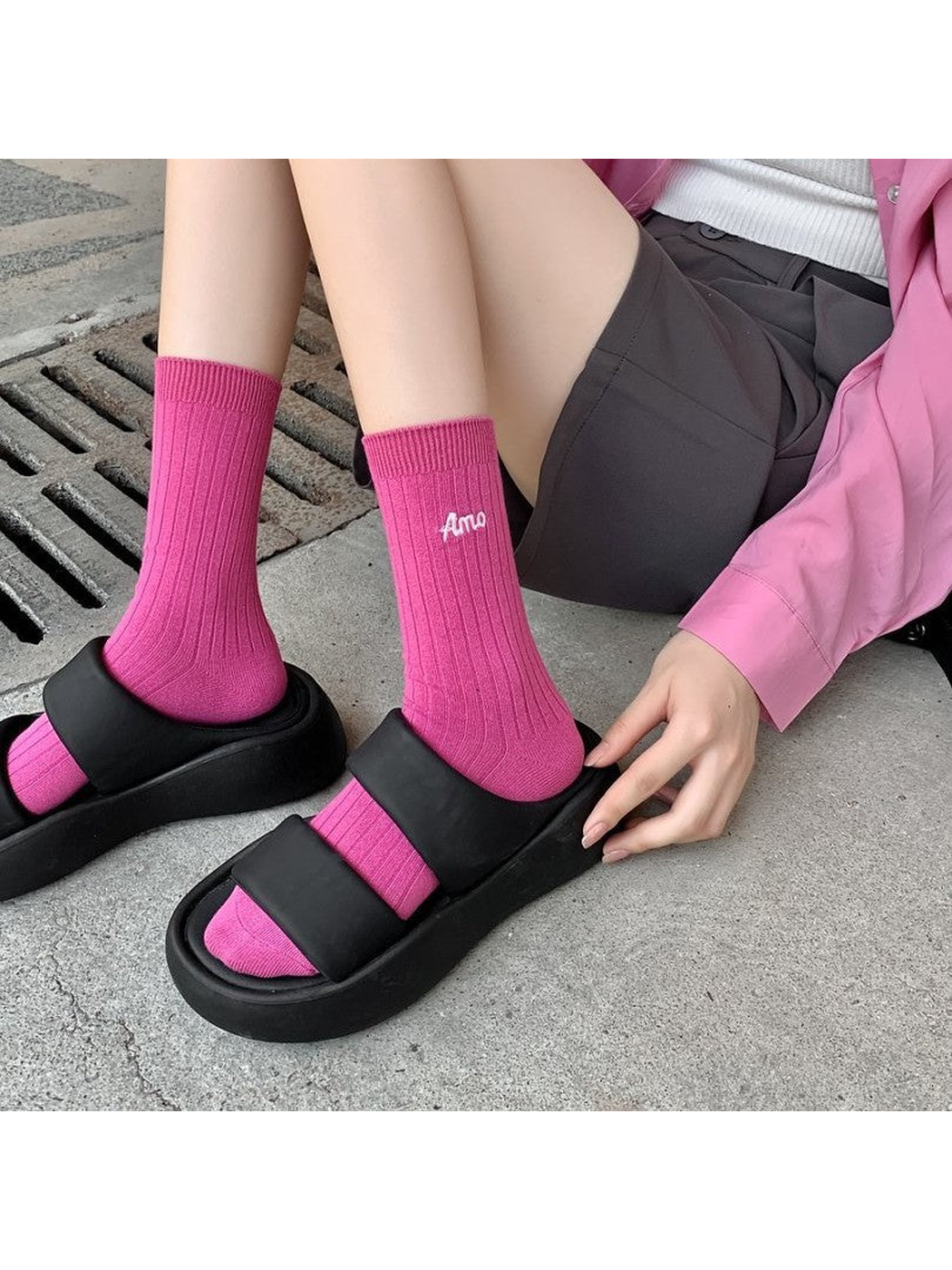 Pink ribbed crew socks worn with black open-toe sandals