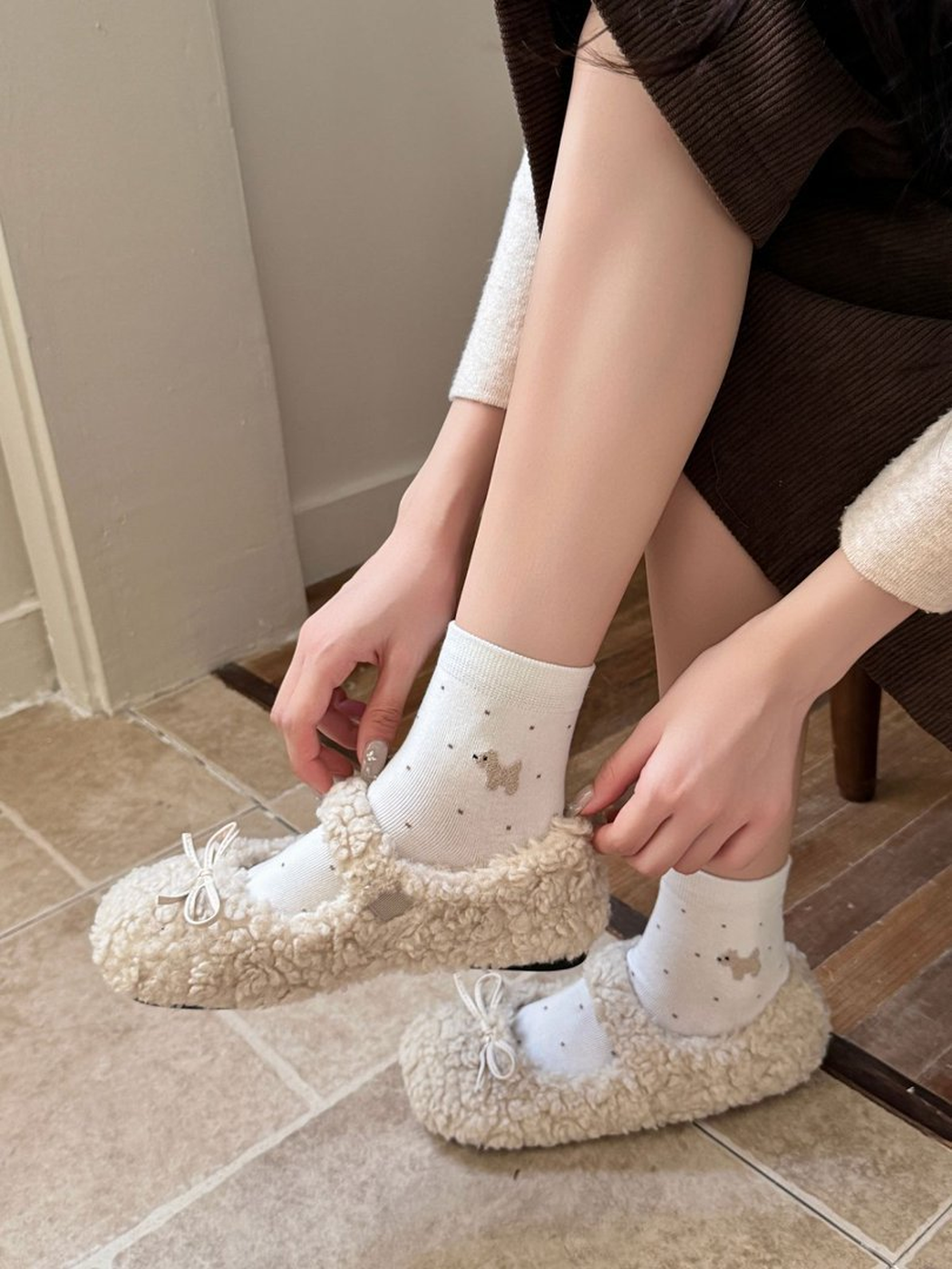 White dotted crew socks worn with cream textured flats