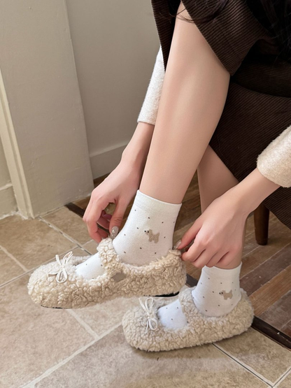White dotted crew socks worn with cream textured flats