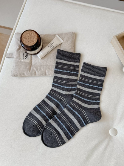 Dark gray crew socks with gray and blue horizontal stripes