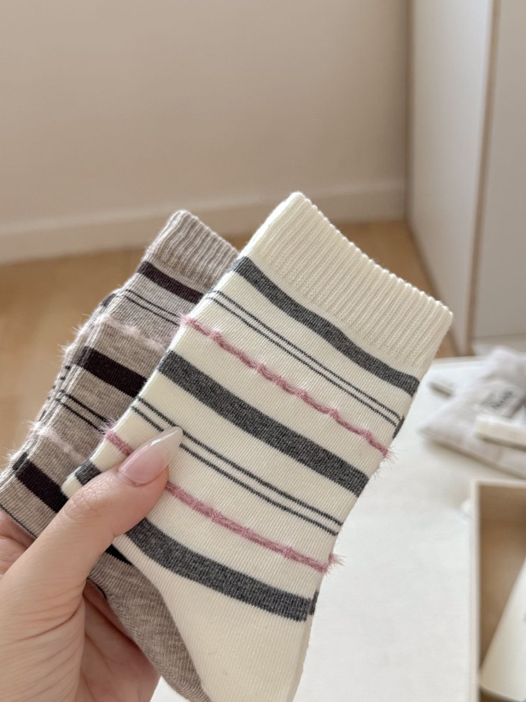Close-up of ribbed cuffs and mixed stripe patterns