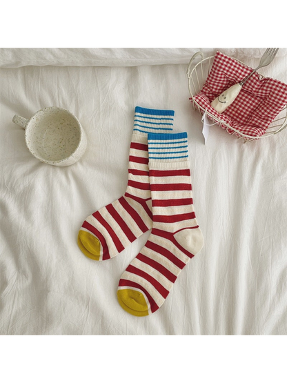 Red and cream striped crew socks with blue cuffs and yellow toes