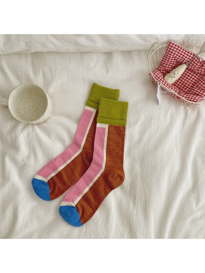 Brown and pink color-blocked crew socks with green cuffs and blue toes