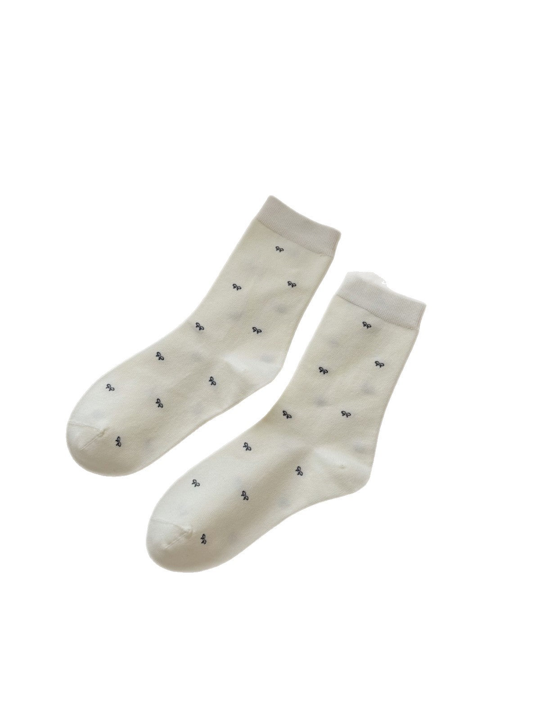 Ivory crew socks with tiny dark bow motifs on a white background