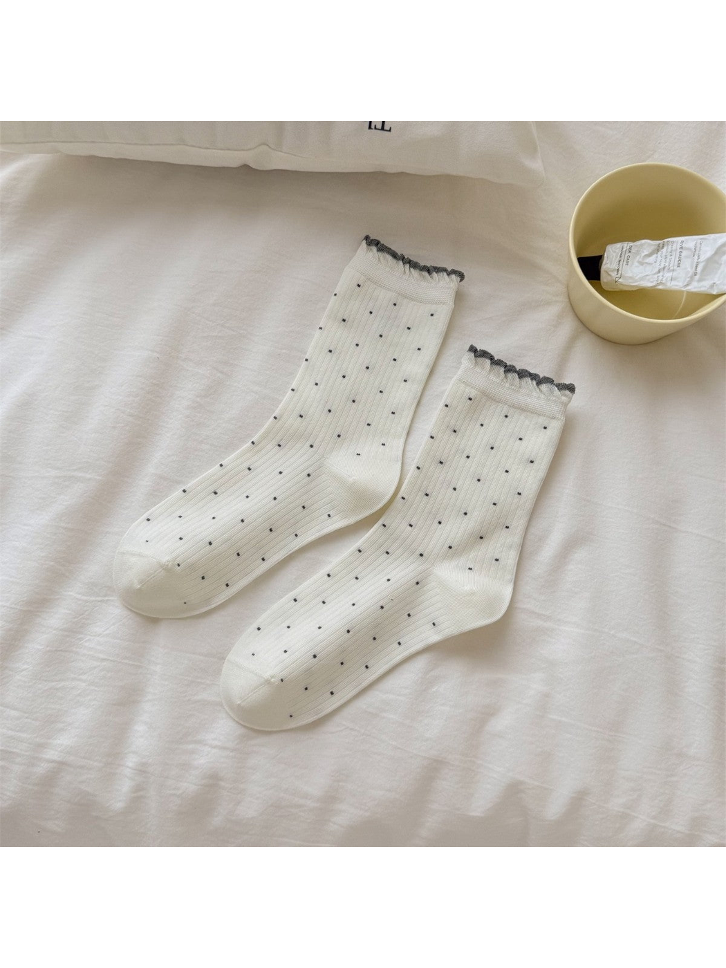 Ivory ribbed crew socks with dark dots and ruffled cuffs