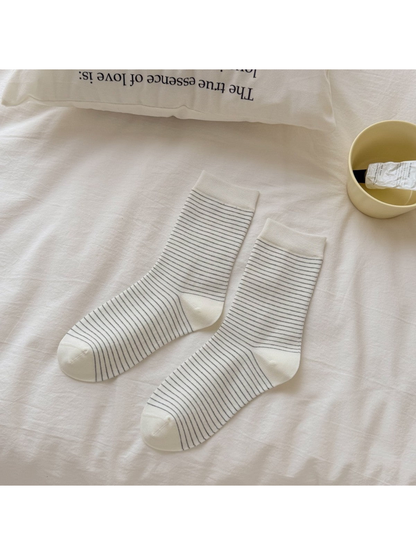 Ivory crew socks covered in fine dark stripes
