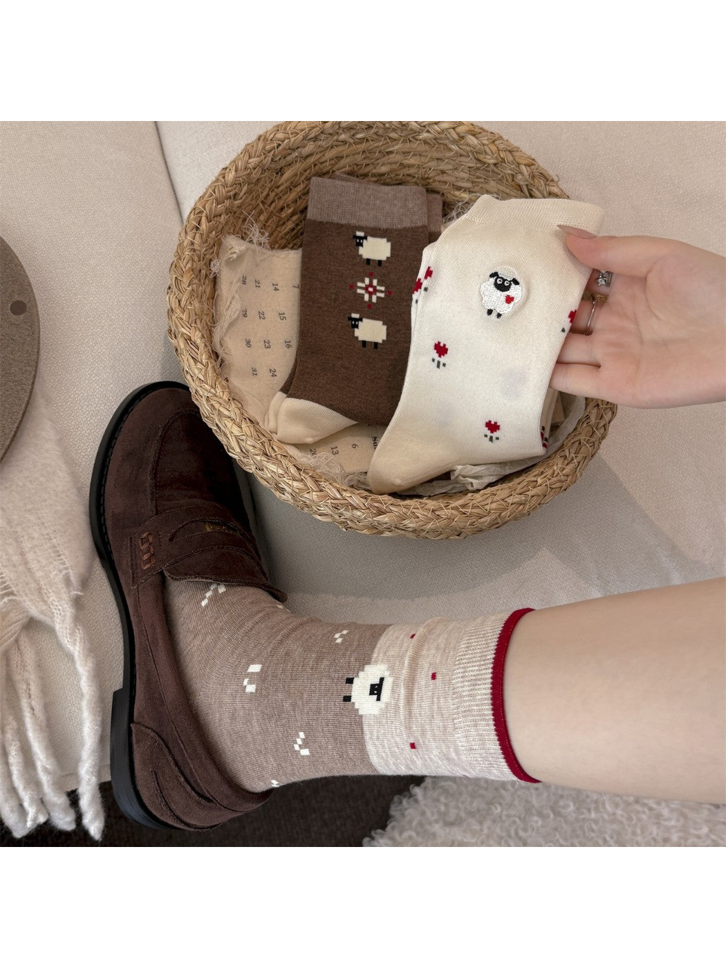 Light coffee sheep socks worn with brown loafers beside ivory and dark coffee styles
