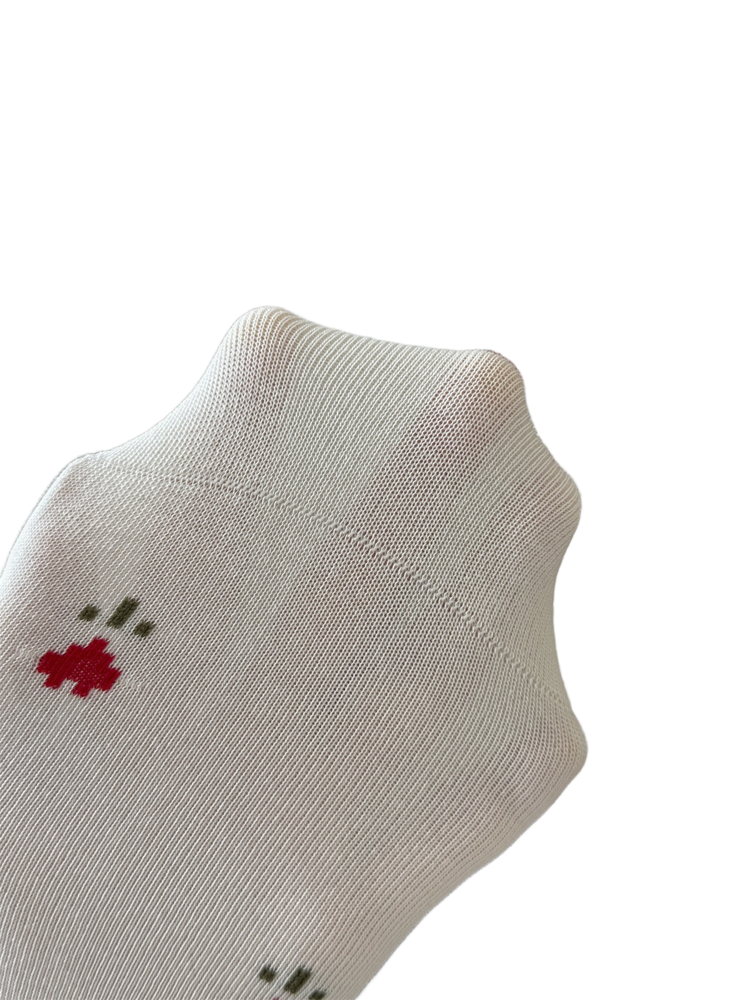 Close-up of the ivory sock's fine knit texture and curved heel construction