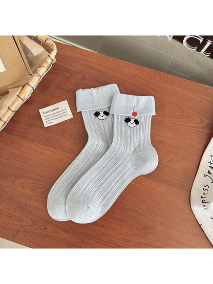 Light blue pointelle crew socks with folded cuffs and panda embroidery