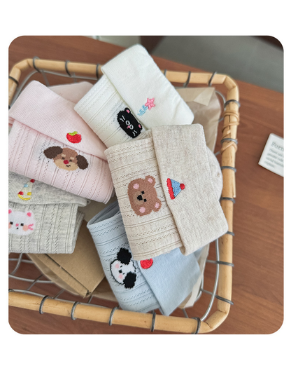 Close-up of folded cuffs and embroidered animal motifs across several sock colors