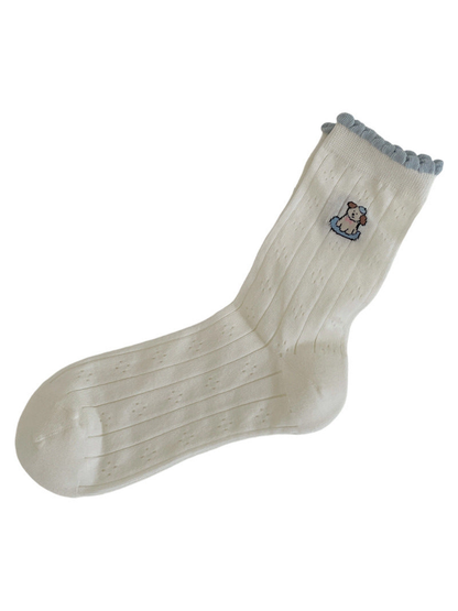 Ivory crew sock with a single dog motif and pale blue scalloped cuff