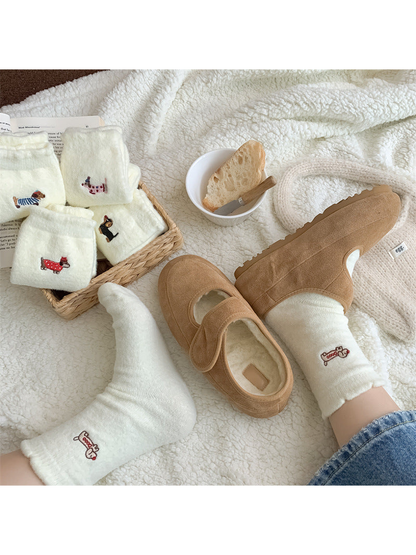 Ivory fuzzy dog motif socks styled with tan slippers