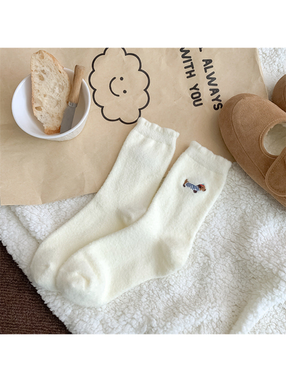 Ivory fuzzy crew socks with blue-striped dog embroidery