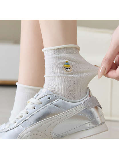 Ivory pointelle crew sock worn with a silver sneaker and gently stretched at the ankle