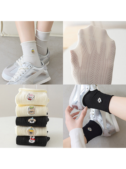 Collage of embroidered crew socks showing worn views, pointelle texture and assorted motifs