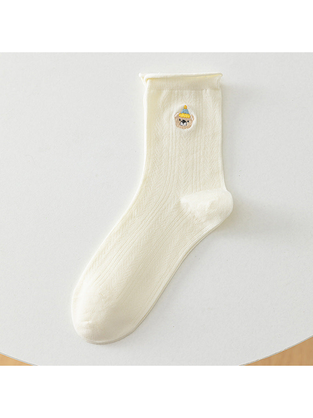 Ivory crew sock with a blue-and-yellow-hat bear motif, full product view
