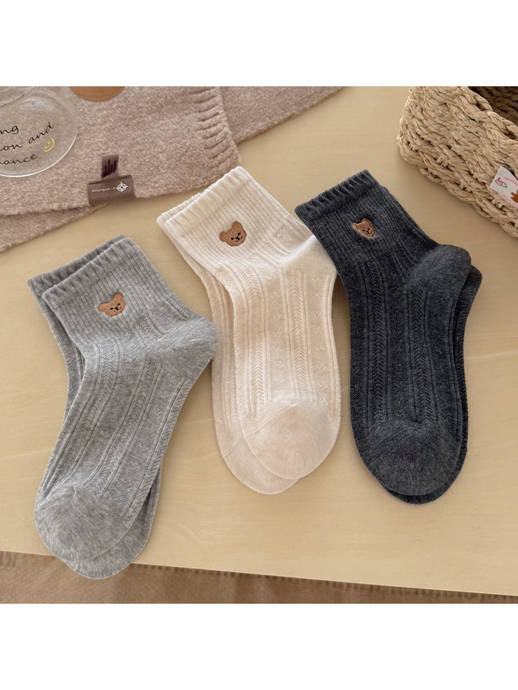 Light gray, cream and dark gray bear-motif ankle socks displayed together