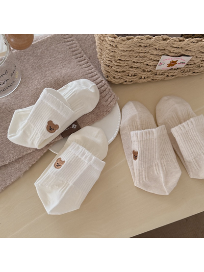 Assorted bear-motif ankle socks arranged on a tabletop