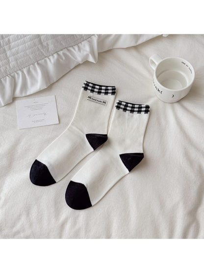 Ivory crew socks with black gingham cuffs and contrast toes and heels