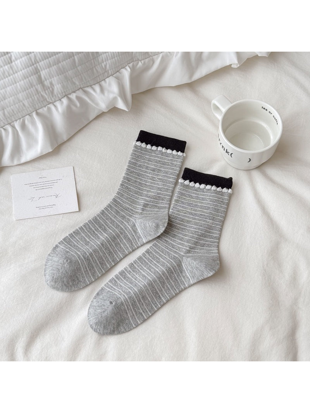 Gray crew socks with fine white stripes and loop-trimmed black cuffs