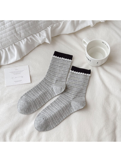 Gray crew socks with fine white stripes and loop-trimmed black cuffs