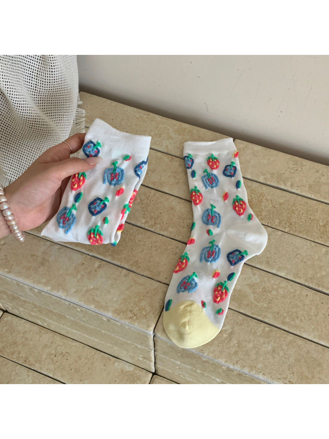 White crew socks with colorful raised fruit motifs